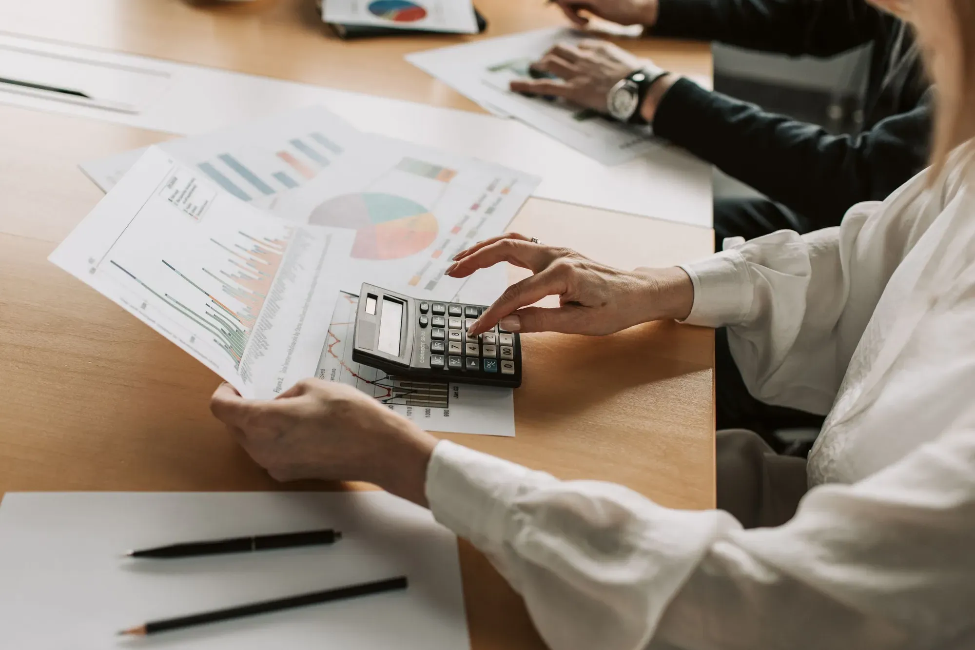 Financial reports being reviewed with a calculator