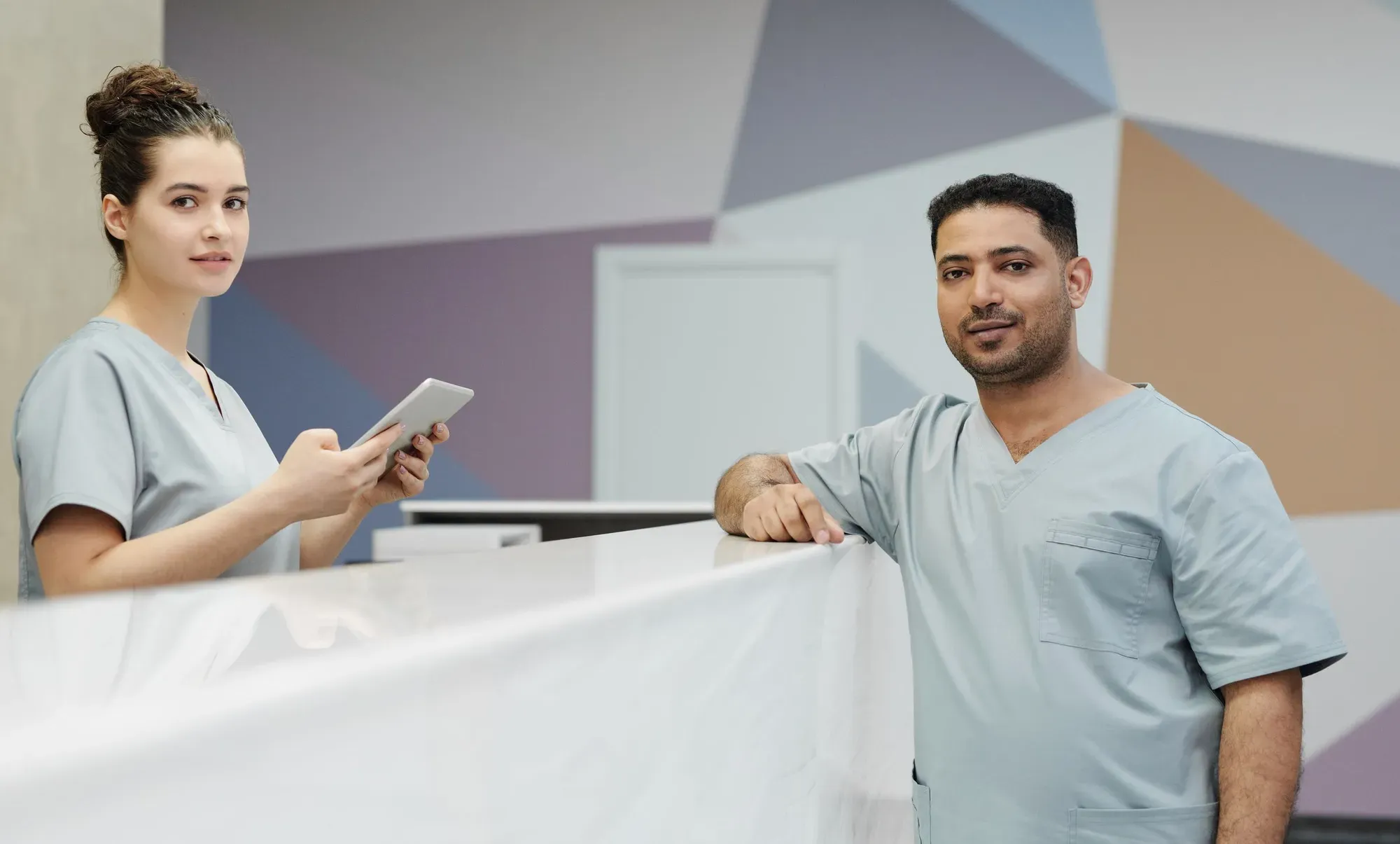 Hospital staff at a modern front desk